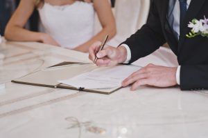 a man signs an important document
